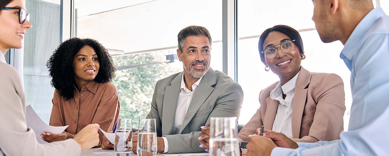 Business leaders and team members collaborating during a meeting, discussing priorities, accountability and organizational leadership.